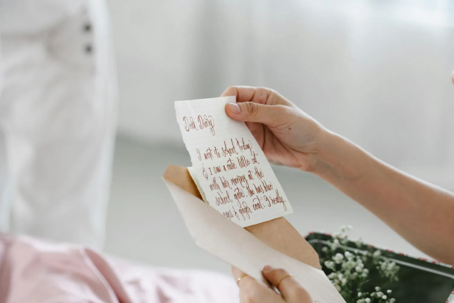 Close-up of a person reading a beautifully handwritten letter, evoking personal connection.